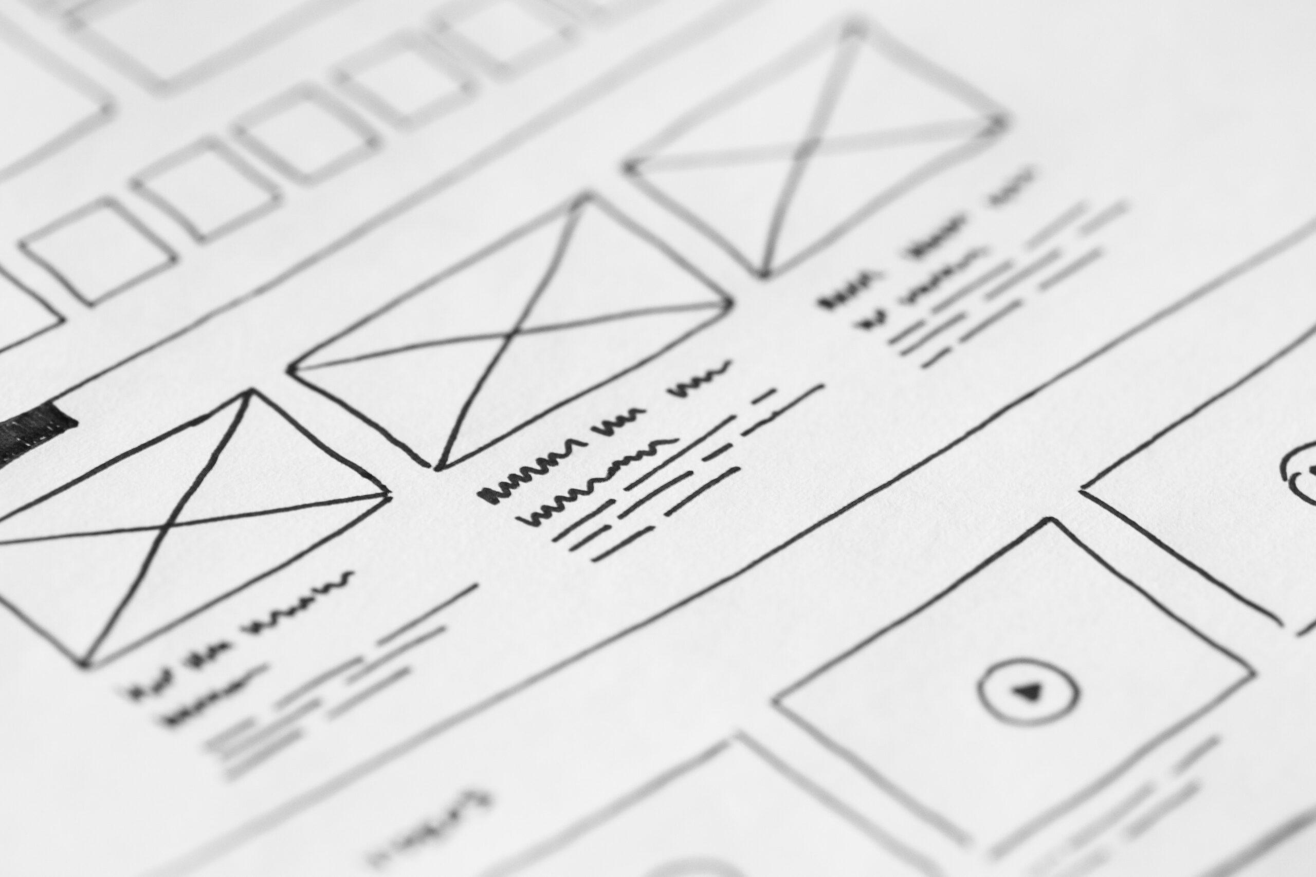 Zoomed-in, hand-drawn low fidelity website wireframes. Indicating that website structure is important when you decide to redesign your website.
